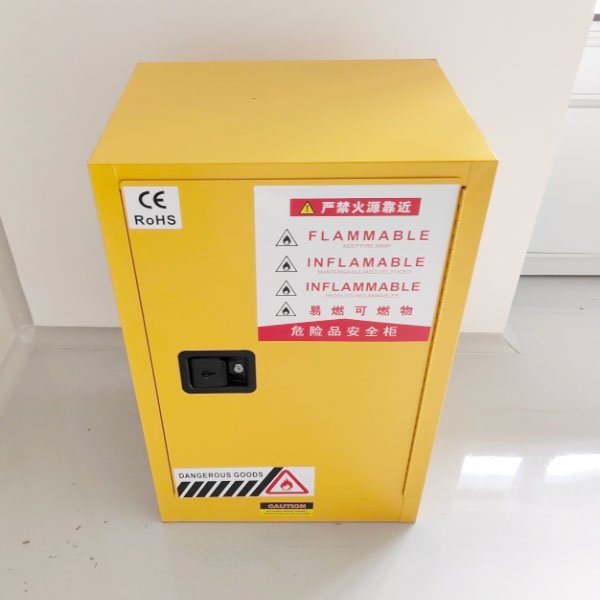 Single-door yellow flammable storage cabinet with CE and RoHS marks and warning labels on a studio background