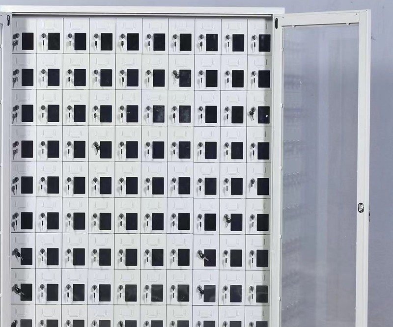 Close-up of phone charging locker bays showing individual key locks, keys and charging sockets