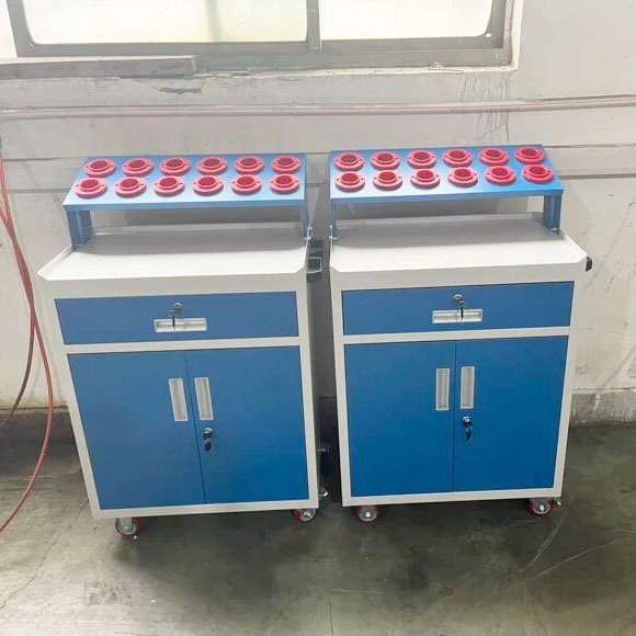 Two mobile tool carts with casters and tool holder trays standing side by side in a workshop
